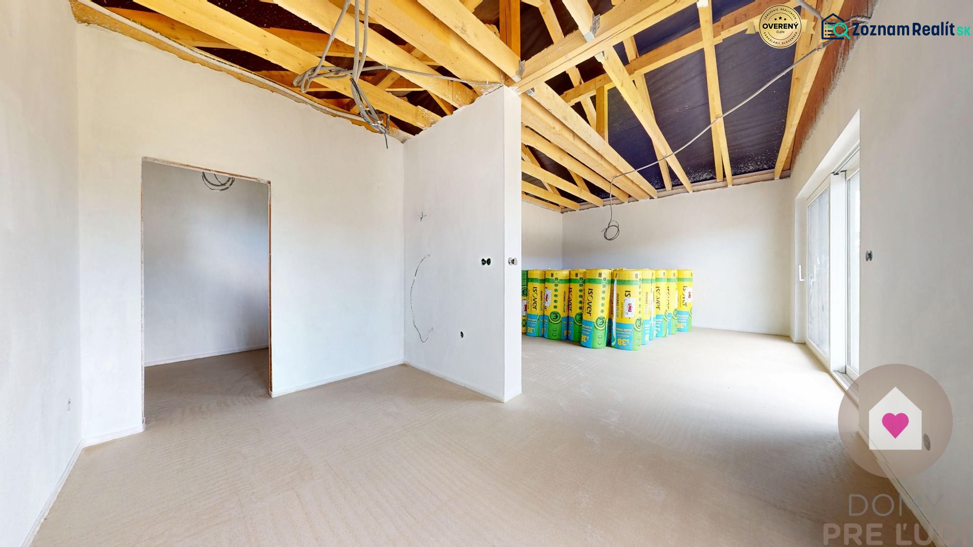 Interior of a family house with an open ceiling and rolls of thermal insulation.