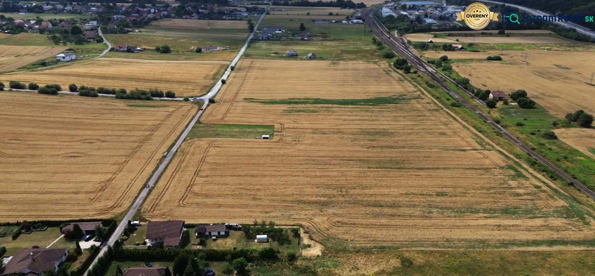 Aerial view of residential land plots in Stožok, with fields and roads.