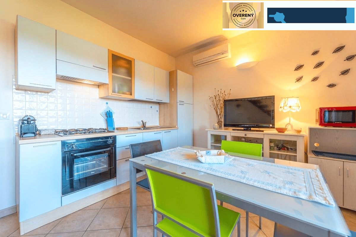 A kitchen in a holiday apartment with a dining table and modern appliances.