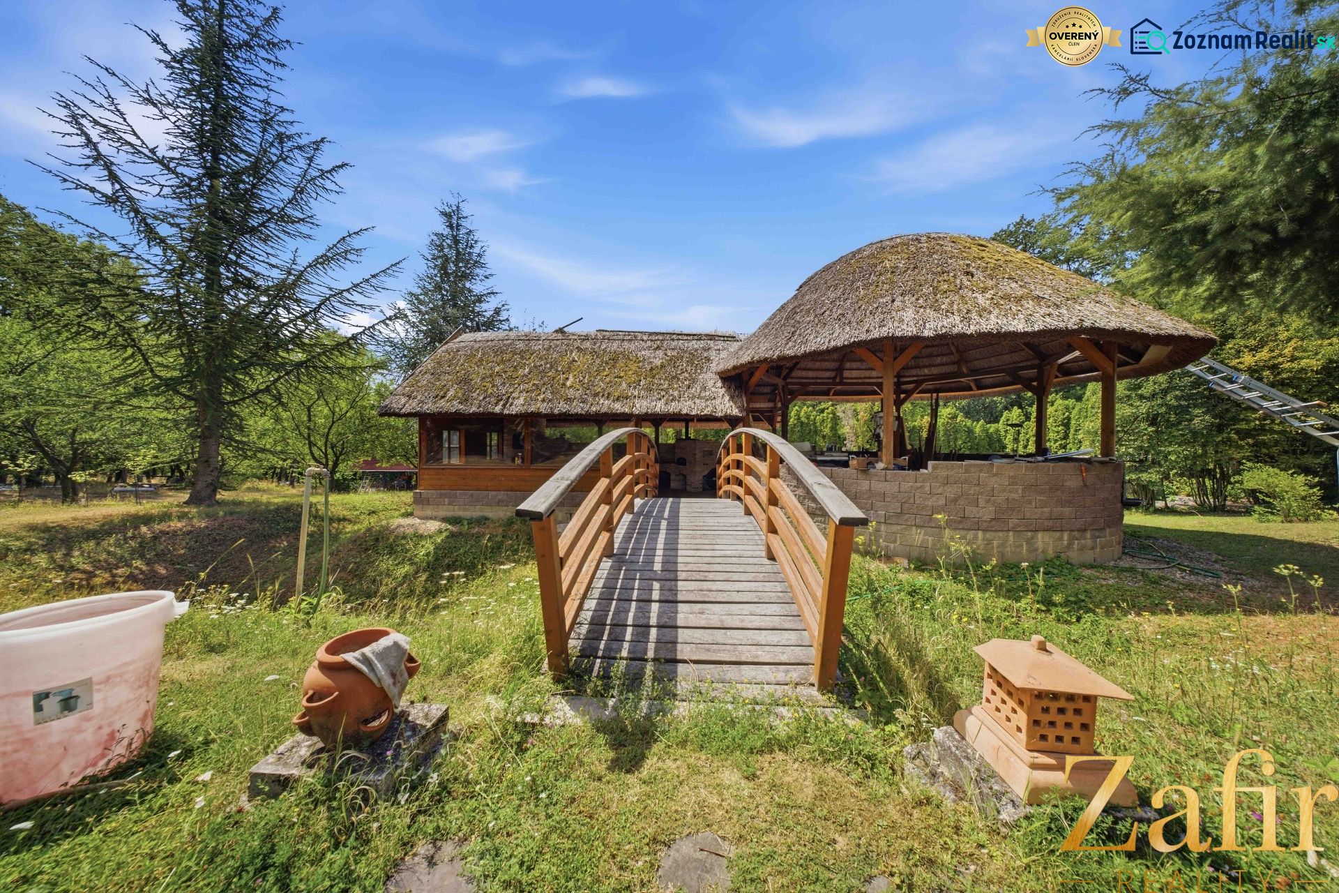 Wooden bridge to the house with a traditional roof in the Recreational Apartment near Trnava.