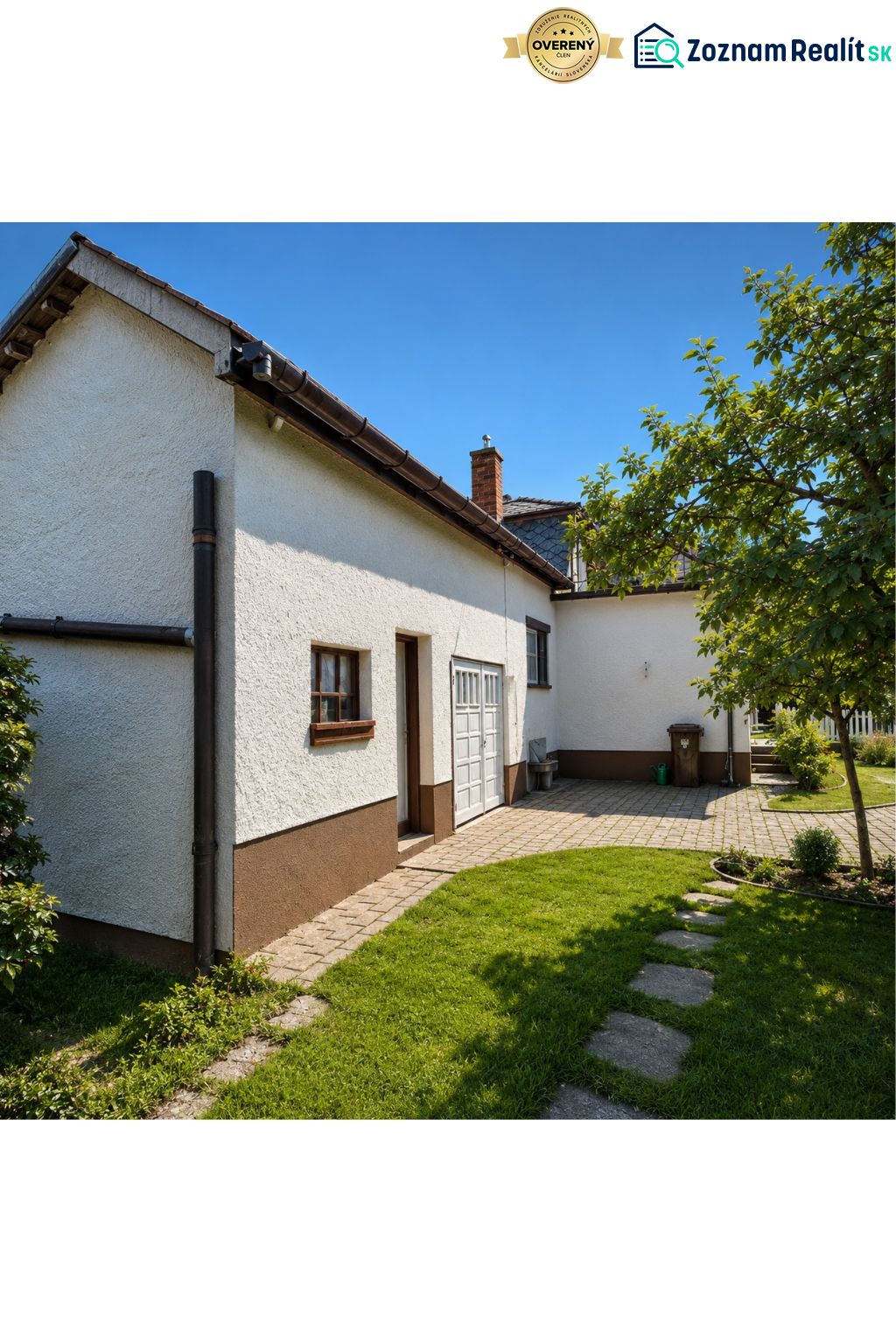 A family house on 29th August Street in Trebišov with a landscaped garden and paving.