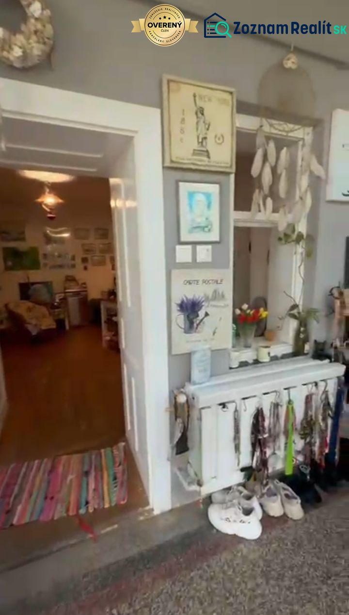 Interior of a family house with wall decorations and carpets at the entrance door.