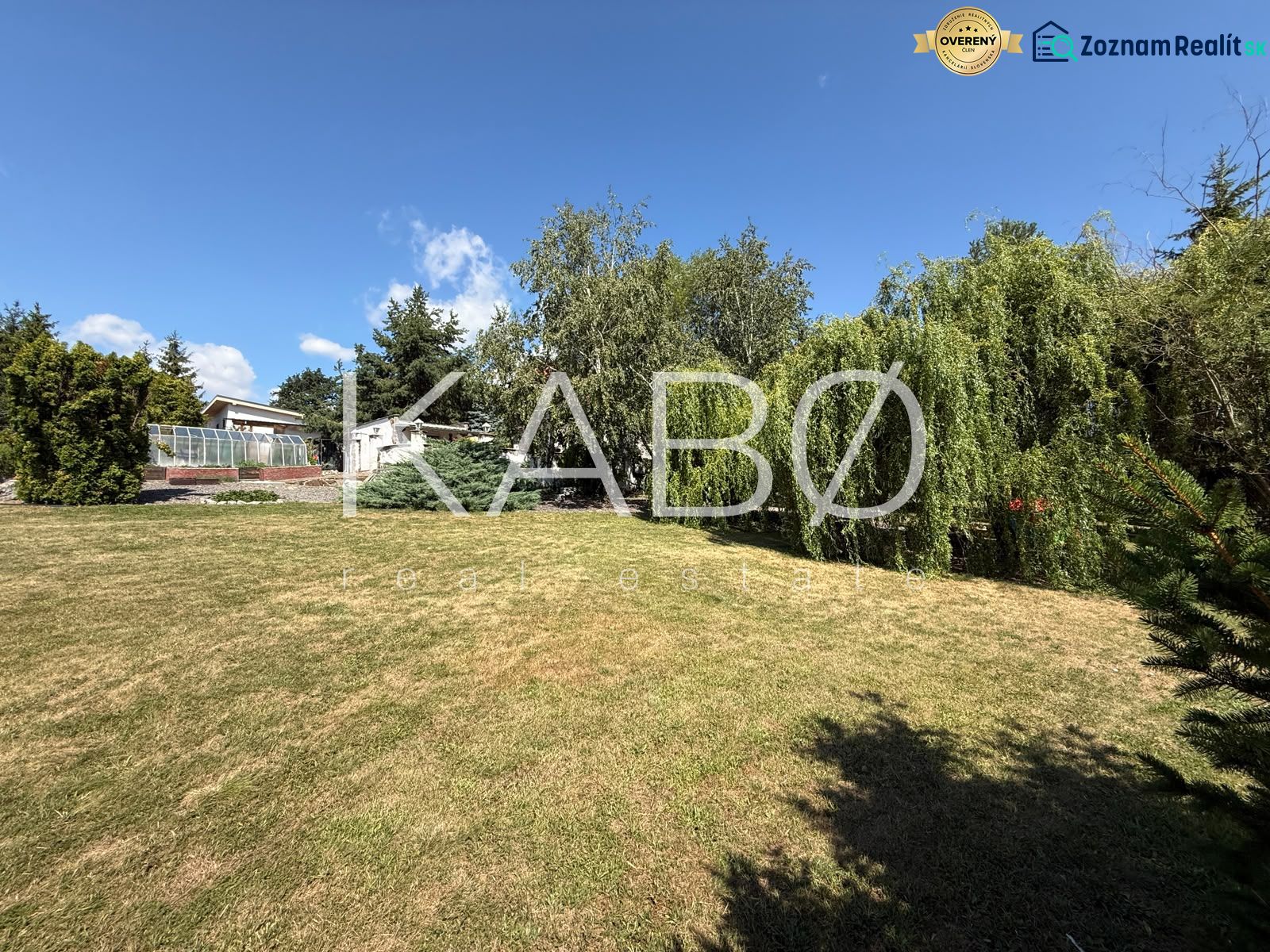 Garden with lawn and trees in the Čaradice area, suitable for residential plots.