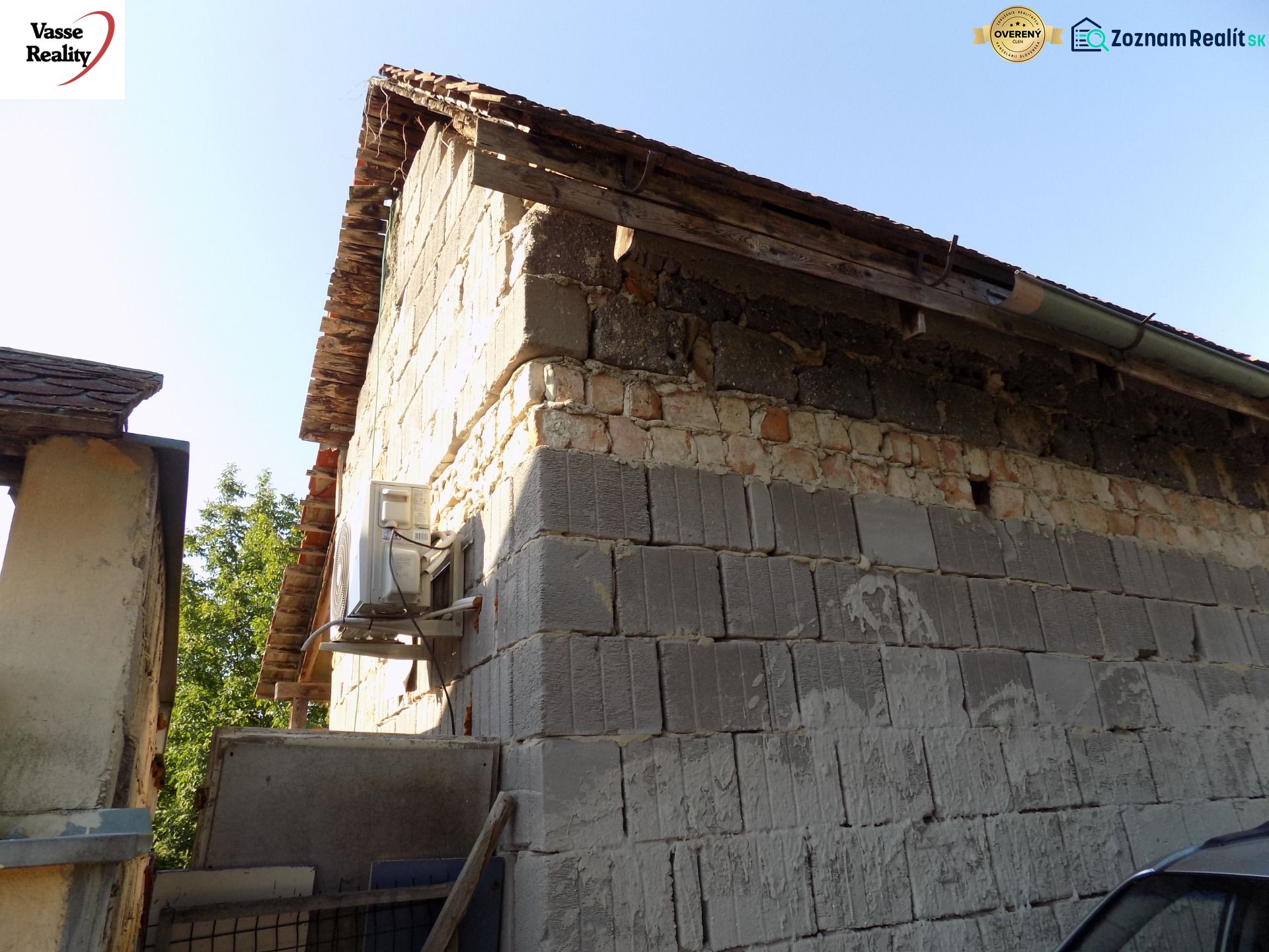 Cottage on the Pumpkin Field in Nové Zámky with a stone wall and an extension.