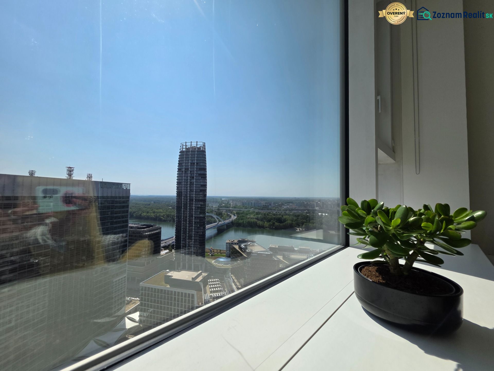 View from the window in Bratislava (Old Town) of the skyline with buildings and greenery.
