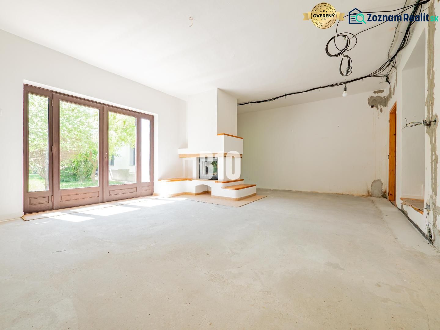 A family house with large windows and a fireplace, waiting for the interior to be completed.