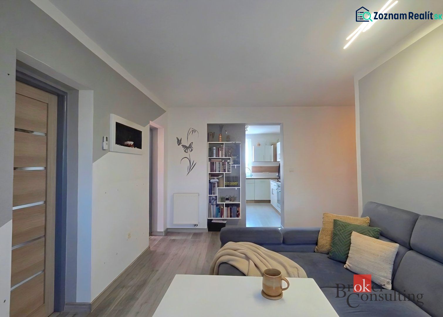 Living room with wooden floor decor and comfortable seating in a 4-room apartment.