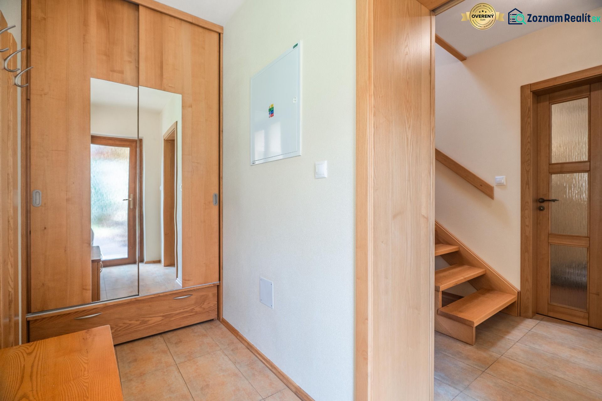 A hallway in a family house with wooden decor and a wardrobe.
