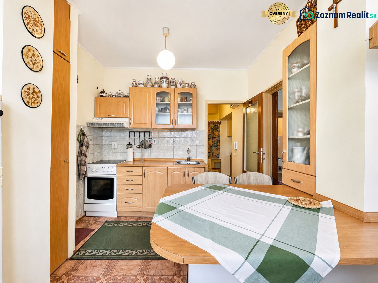 A kitchen unit in a one-room apartment with wooden accessories and appliances.