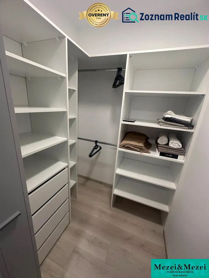 Storage space with shelves, drawers, and a wooden decor floor in a 2-room apartment.