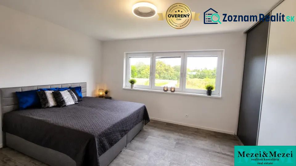 Bedroom with a large bed and a view, family house in Trnava.