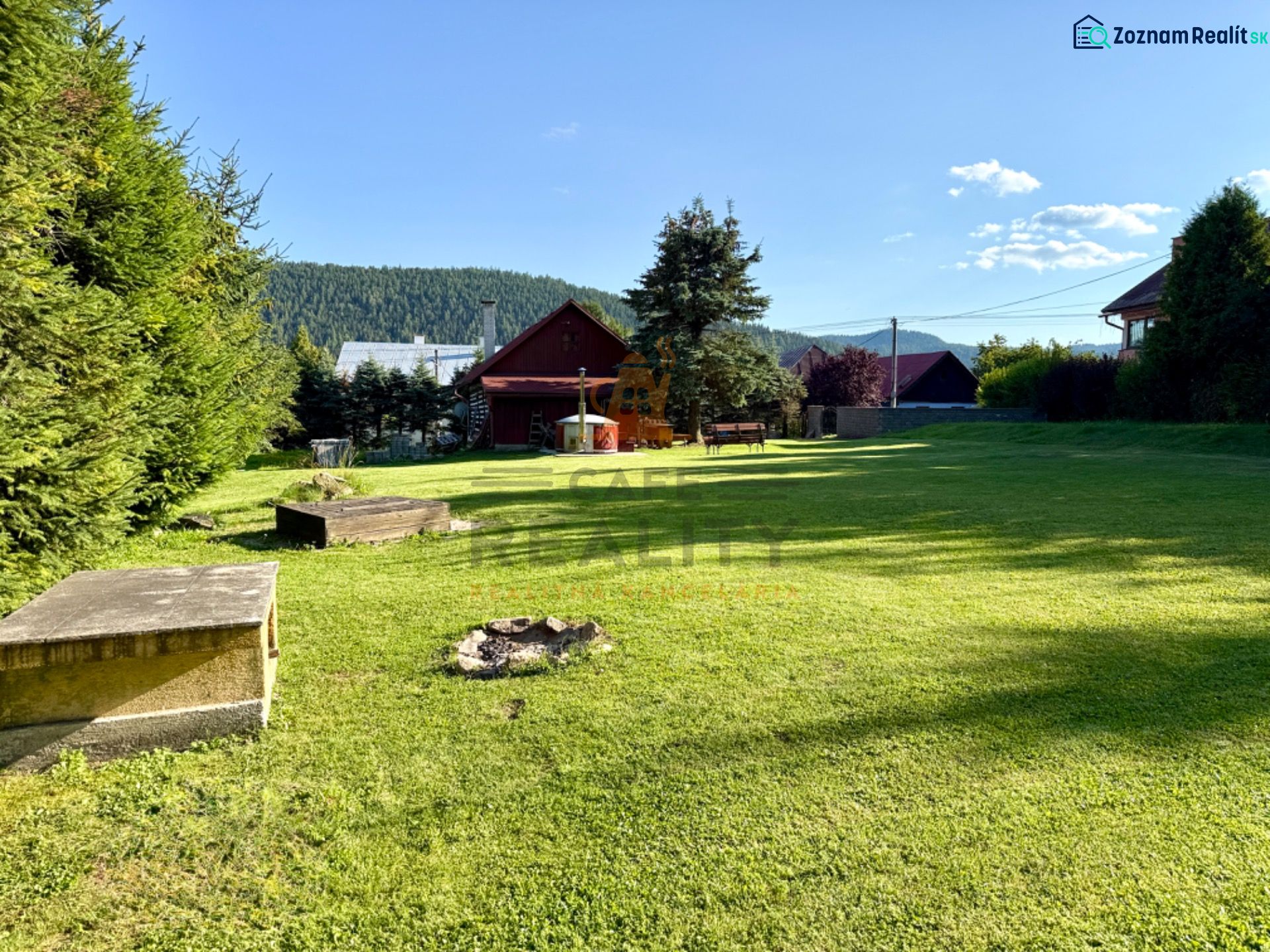 The garden at the family house on Jána Švermu Street in Šumiac with a lawn and a fireplace.