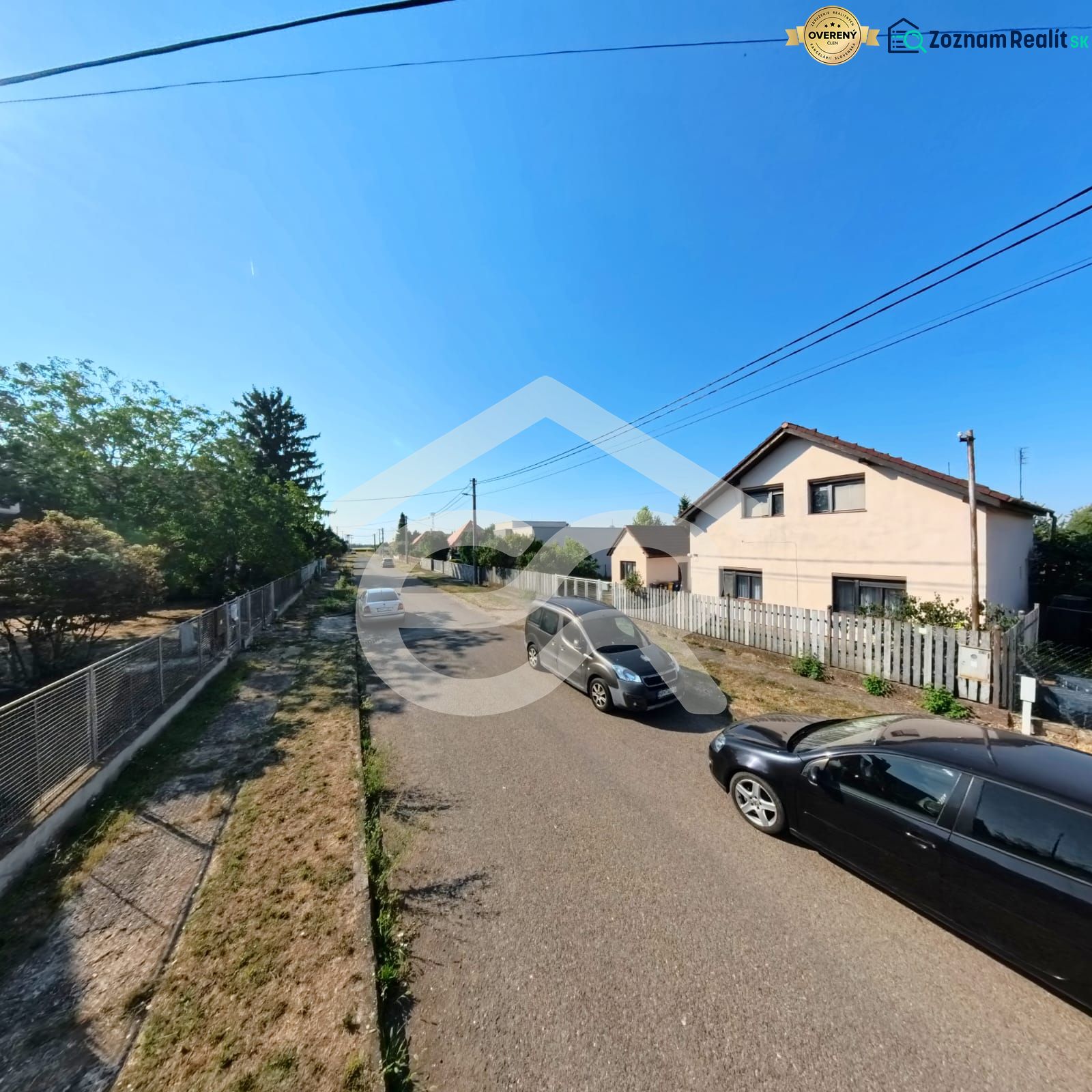 House on Prenosilova Street in Mojmírovce, next to the road with cars and fences.