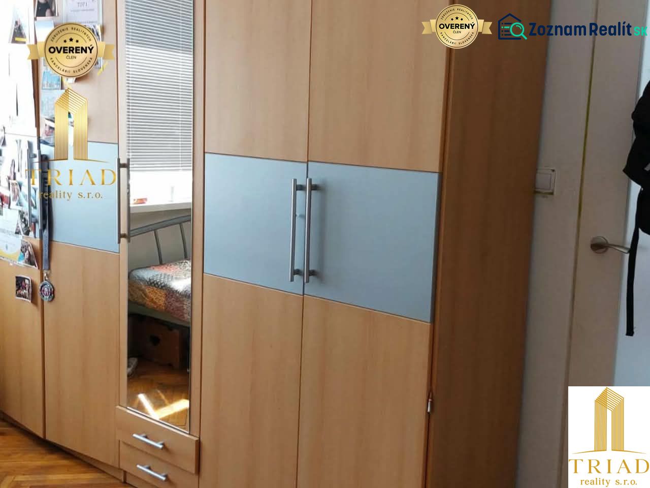 A wardrobe with a wooden decor floor in a studio apartment.
