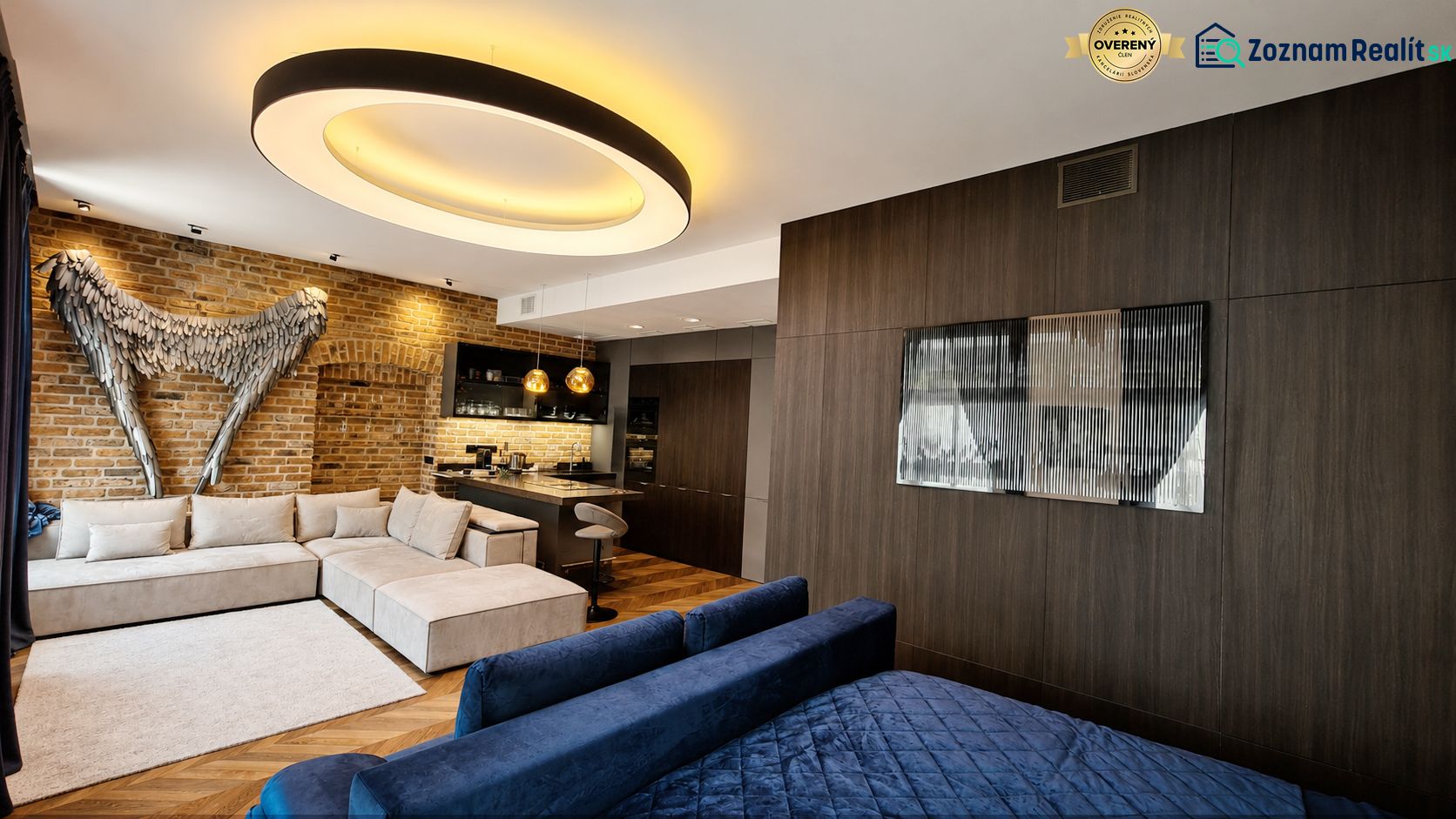 A room decorated with brick, a sofa, and modern lighting, complemented by a floor with a wooden decor.