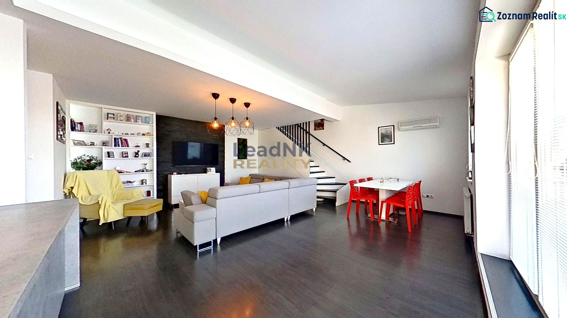 Living room in a three-room apartment with a wooden decor floor, bright interior.