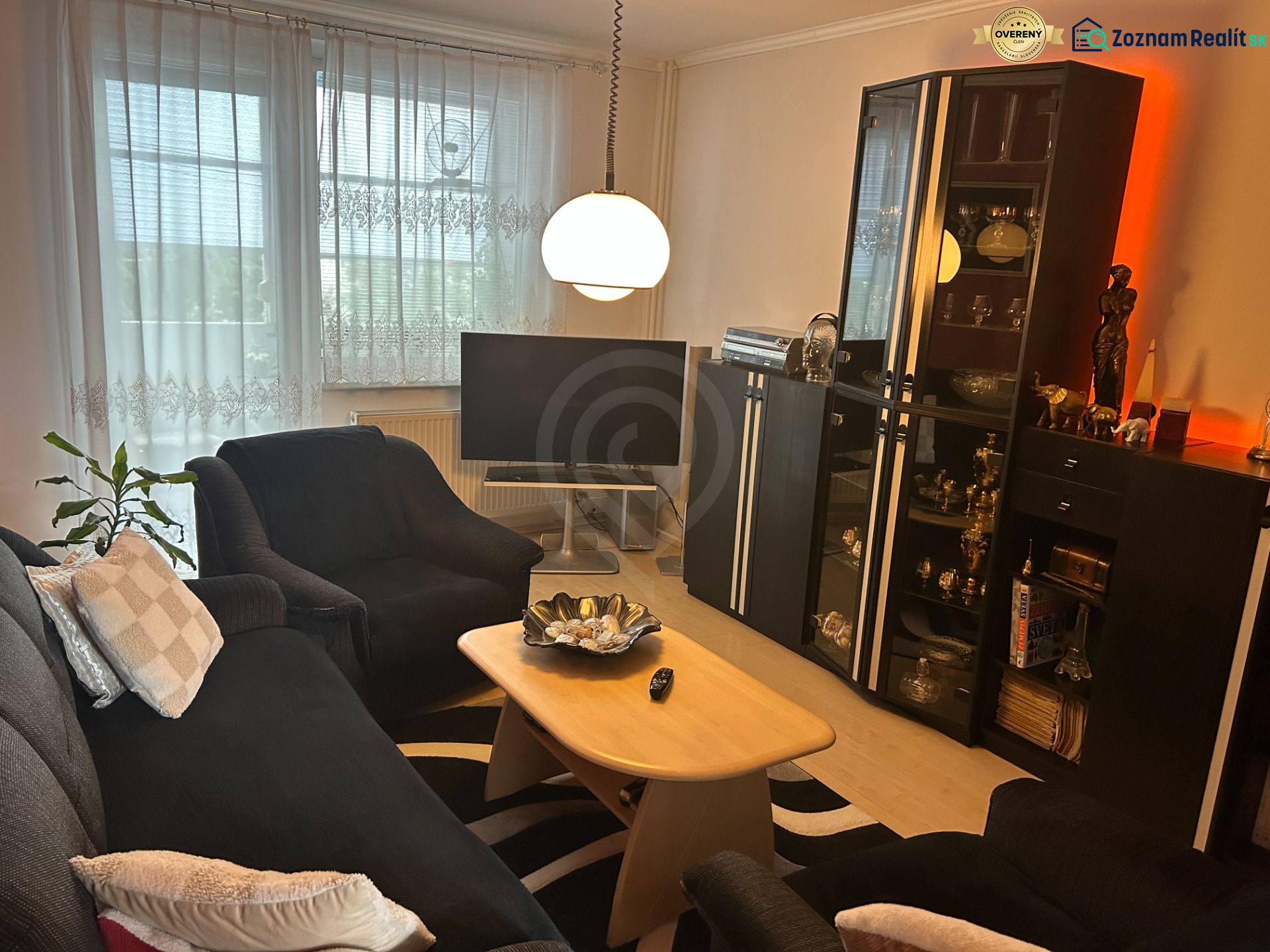 Living room in a 3-room apartment with comfortable seating and a floor lamp.
