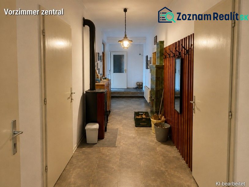 A hallway in a family house with a coat rack, mirror, and stove, and a floor with a wooden decor.