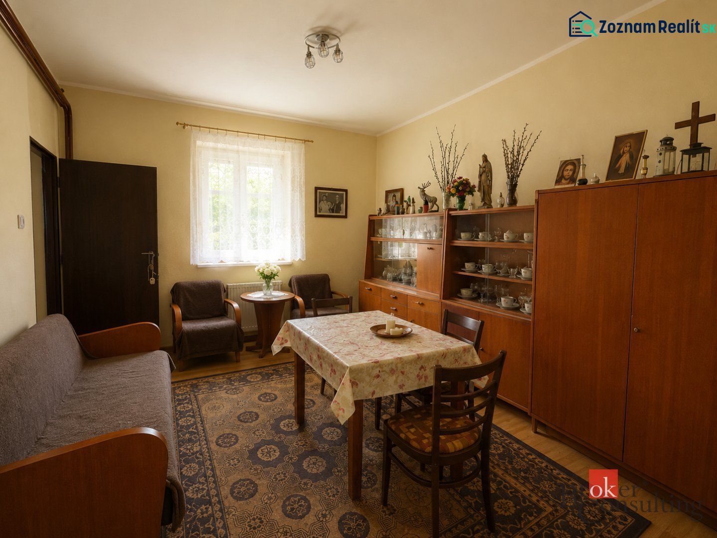 Living room with wooden furniture, wood-patterned flooring, a carpet, and decorative items.
