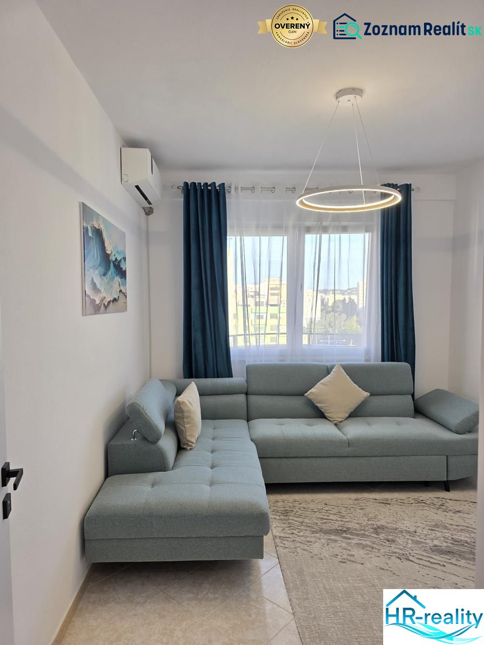 Living room in a 2-room apartment with a comfortable sofa and stylish lighting.