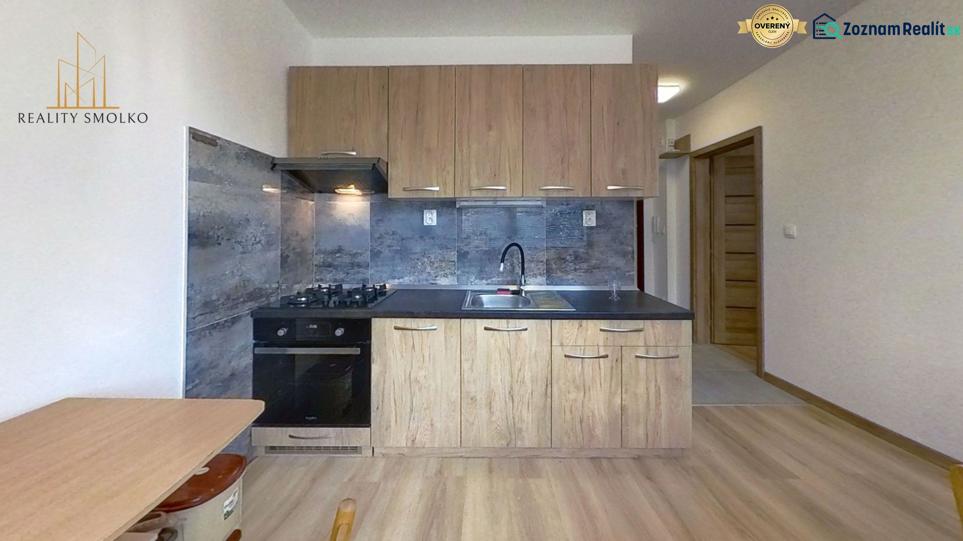 A kitchen with a wooden decor and a countertop in a studio apartment.