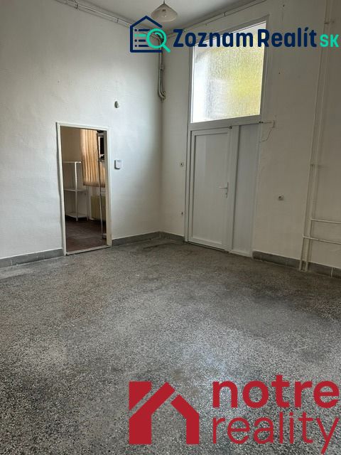 An office interior with white walls and a floor with a concrete effect decor.