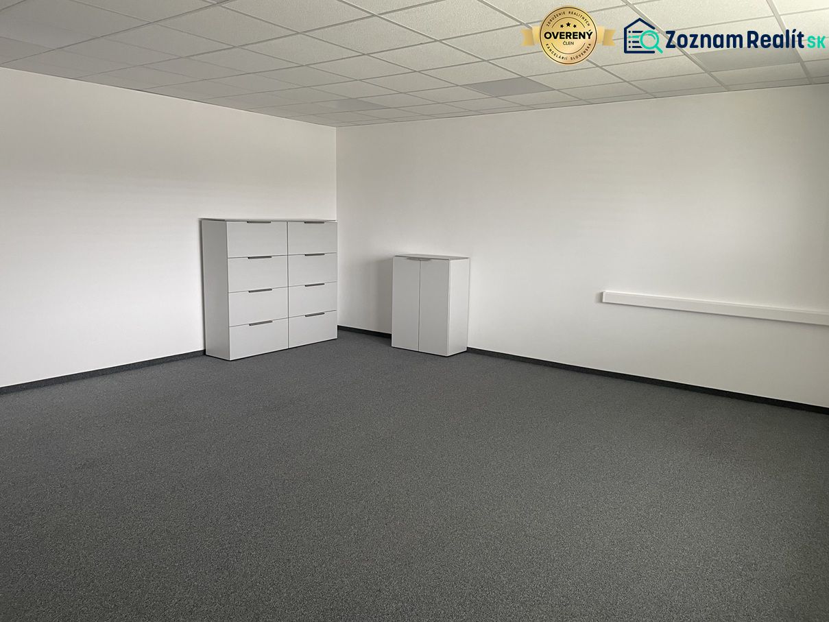 Empty office space with white furniture and gray carpet.