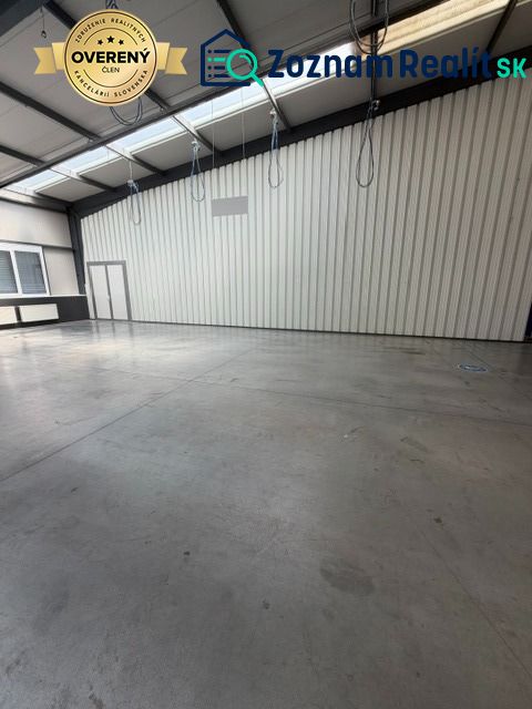 Spacious interior of warehouses and halls with high ceilings and concrete floors.