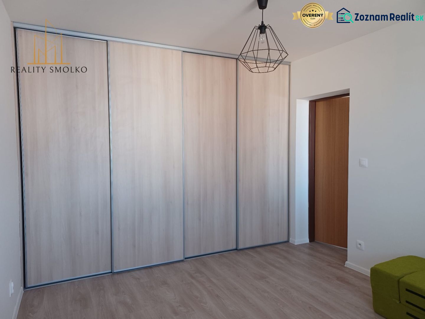 In the 2-room apartment, there is a built-in wardrobe and a floor with a wooden decor.