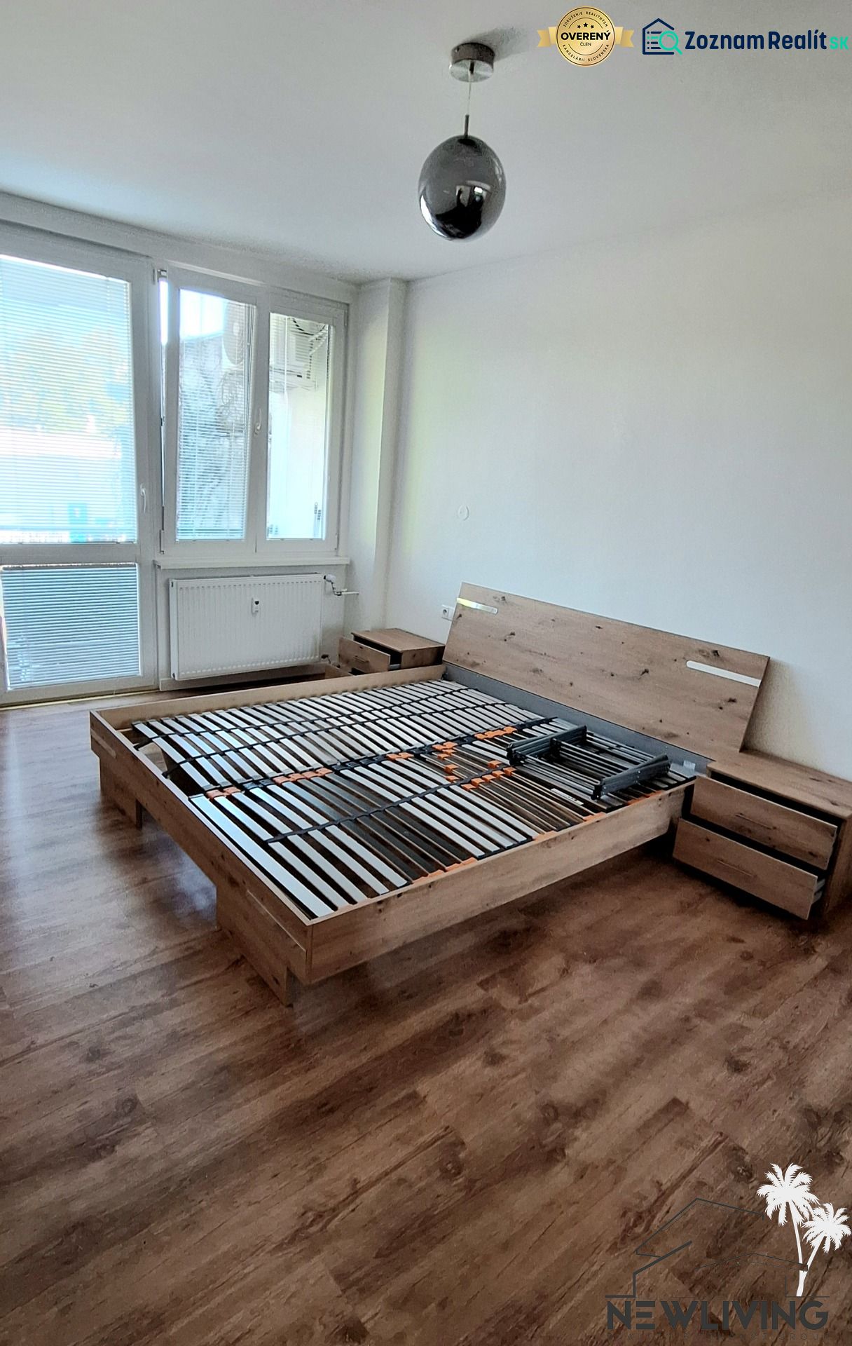 Bedroom in a 2-room apartment with a bed and a floor with a wooden decor.