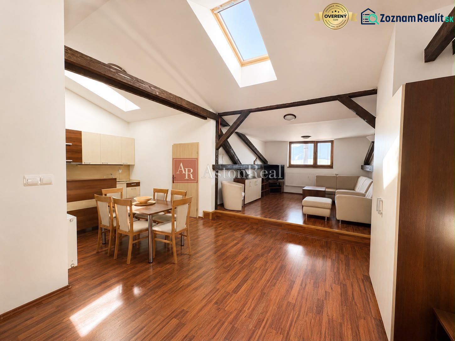 Open space with skylights, a dining table, and a wooden decor floor in a 3-room apartment.