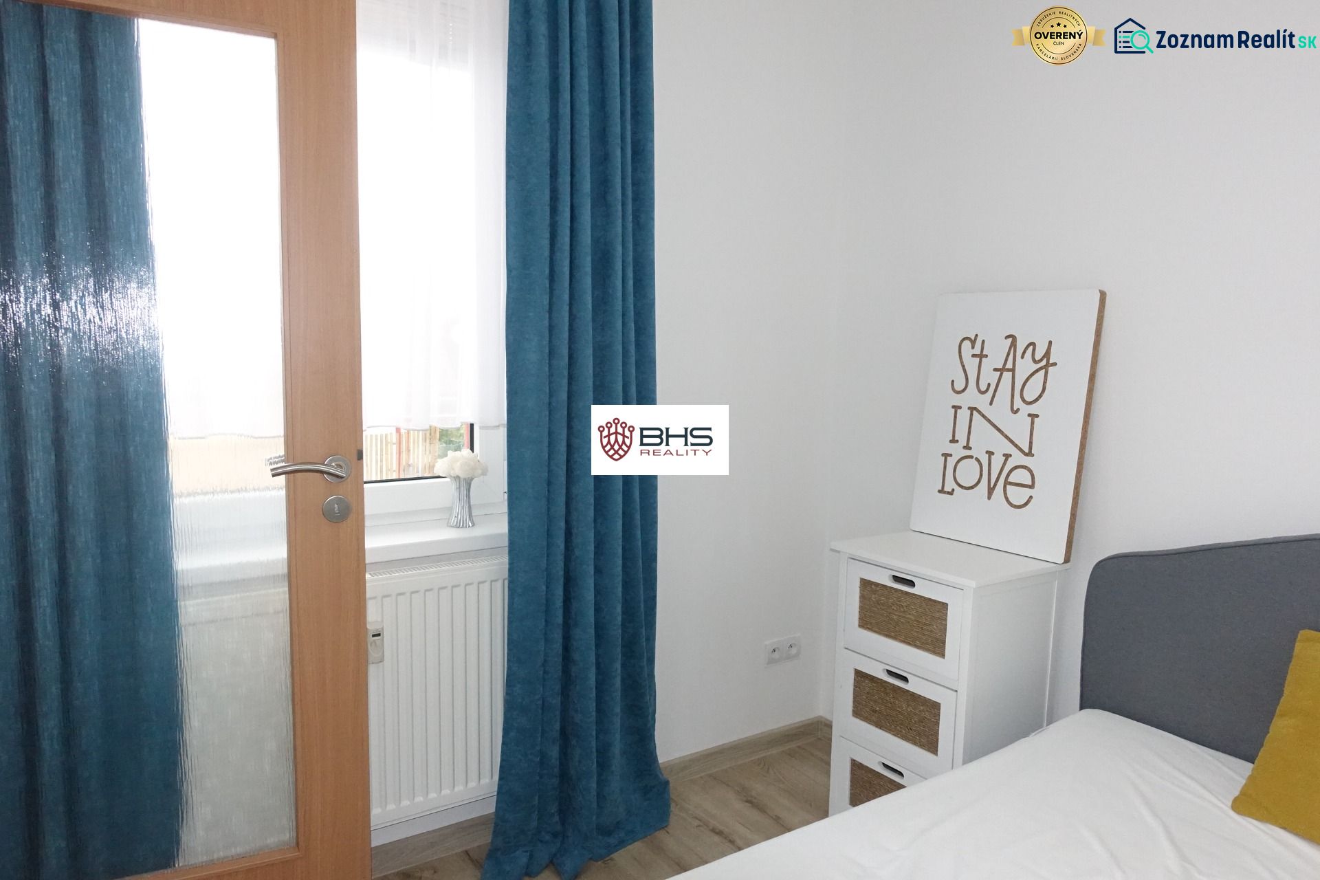 Interior of a 2-room apartment with white walls, curtains, and wooden doors.