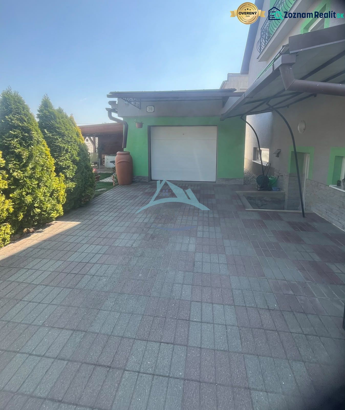 A family house on Tešmak Street in Šahy with a garage and a paved courtyard.
