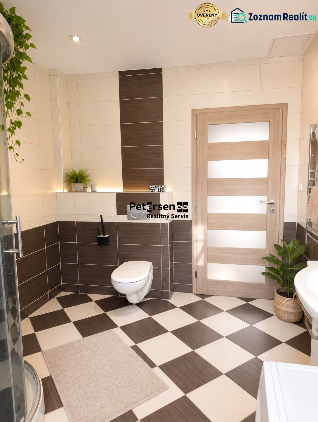 A bathroom in a 3-room apartment with brown-beige tiles and a shower.