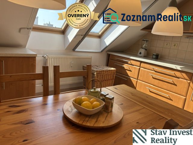A kitchen in a 4-room apartment with a wooden decor floor and skylights.