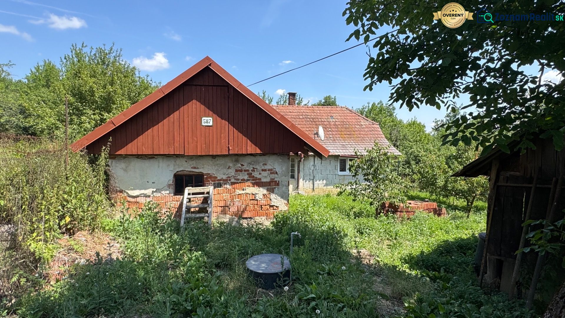 A family house on Kamenec Street in Vrbovce, with an unkempt garden and a brick facade.