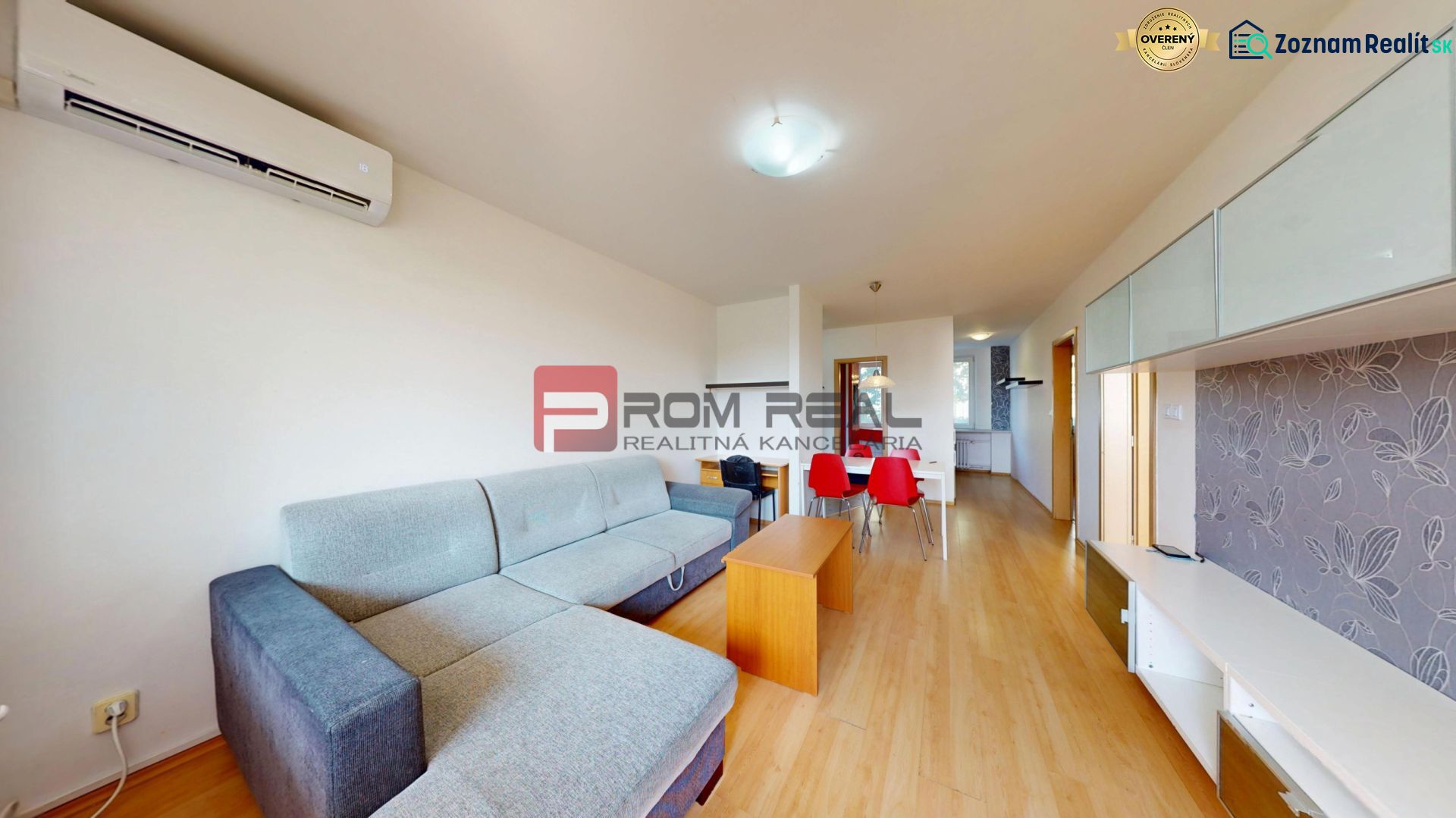 Living room in a 3-room apartment with a wooden decor floor and a sofa.