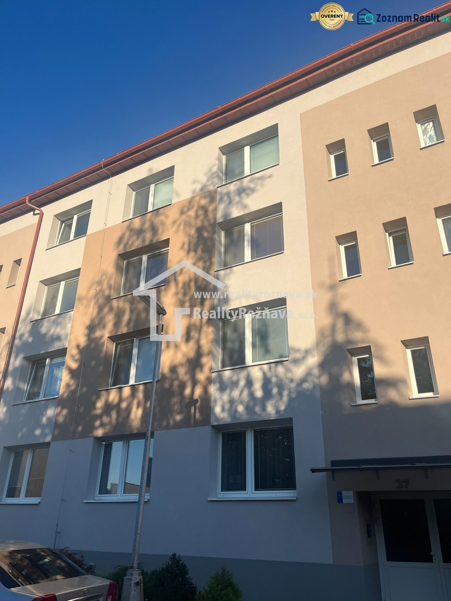 An apartment building in Rožňava offering a 2-room apartment under a clear sky.