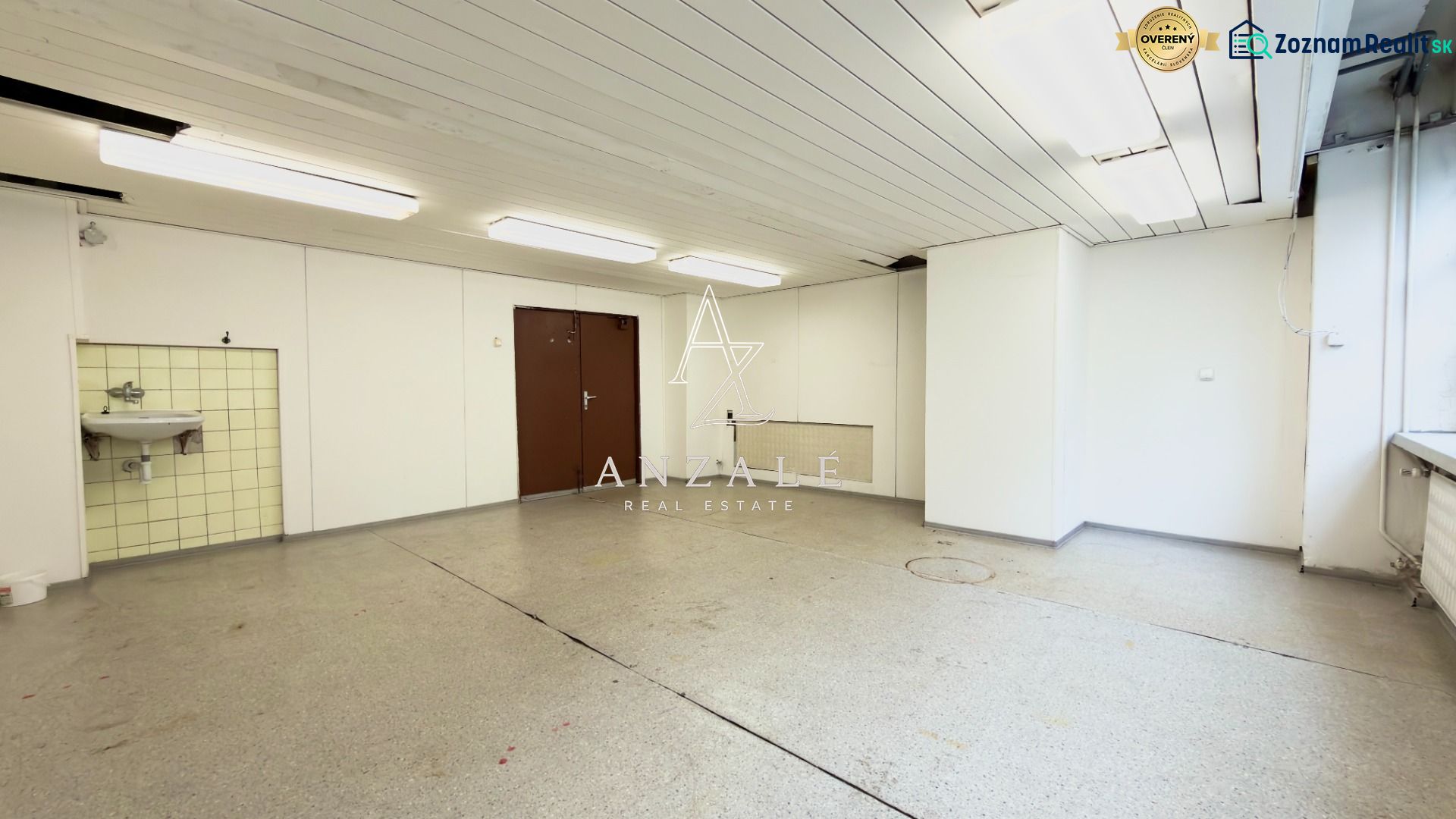 Spacious rooms with white walls, lighting, and a sink in warehouses and halls.