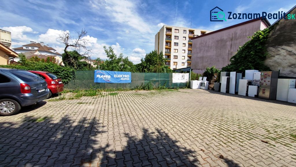 Parking lot on Piešťanská Street in Nové Mesto nad Váhom, surrounded by buildings and greenery.
