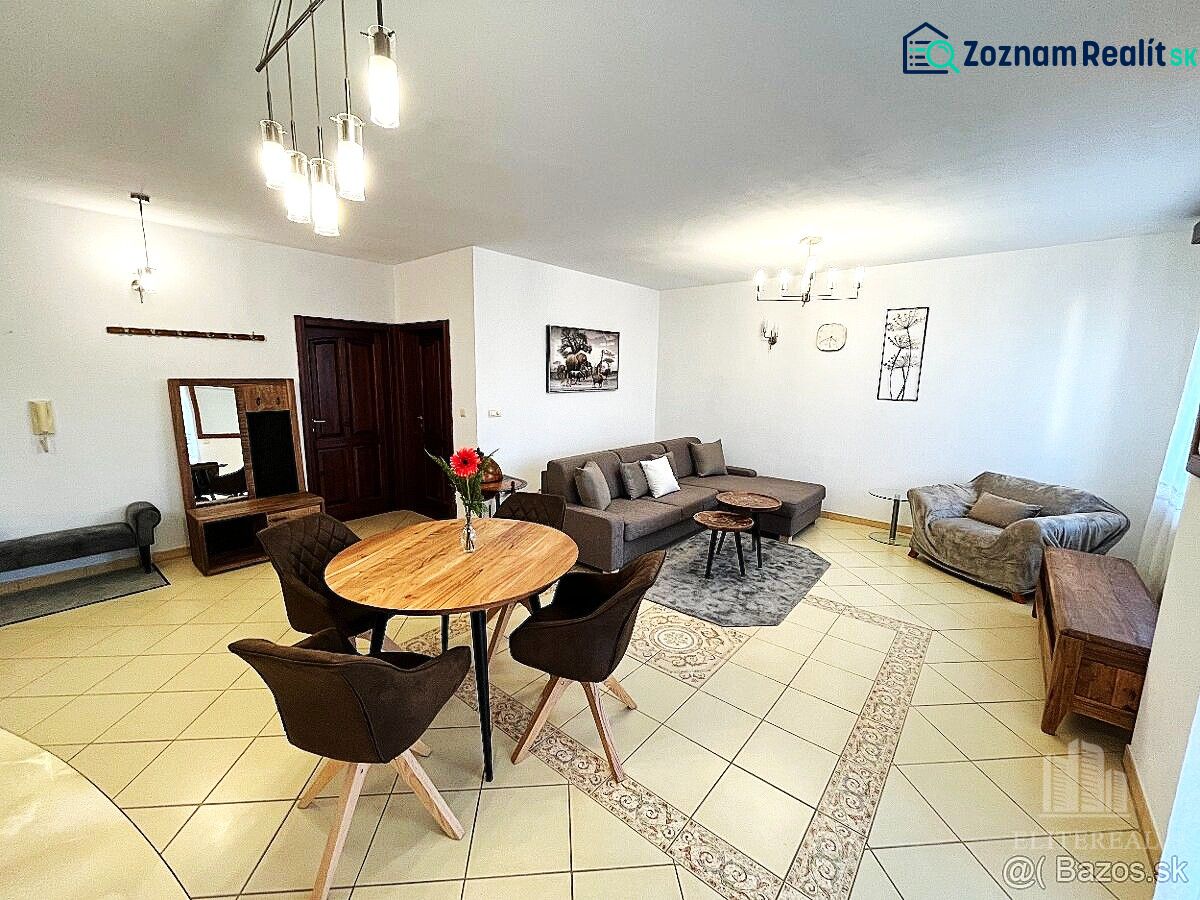 Living room in a three-room apartment with tiles, a sofa, and a dining table.