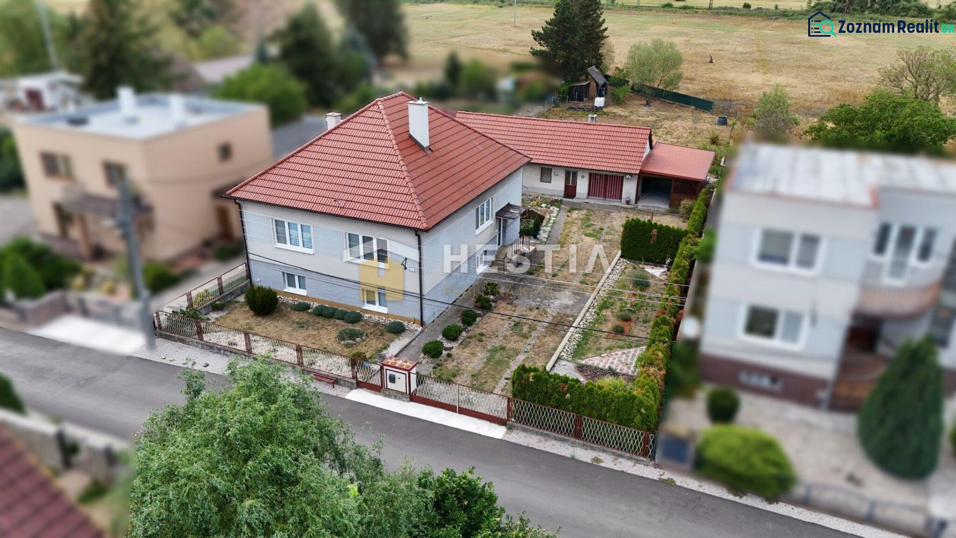 A family house in Šajdíkovce Humence with a landscaped garden and a red roof.