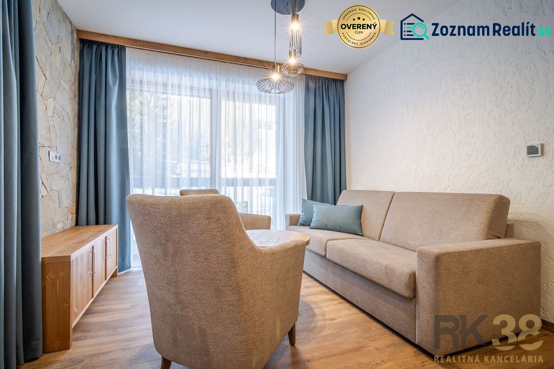 Recreational apartment with a comfortable sofa, armchair, and wooden decor flooring.