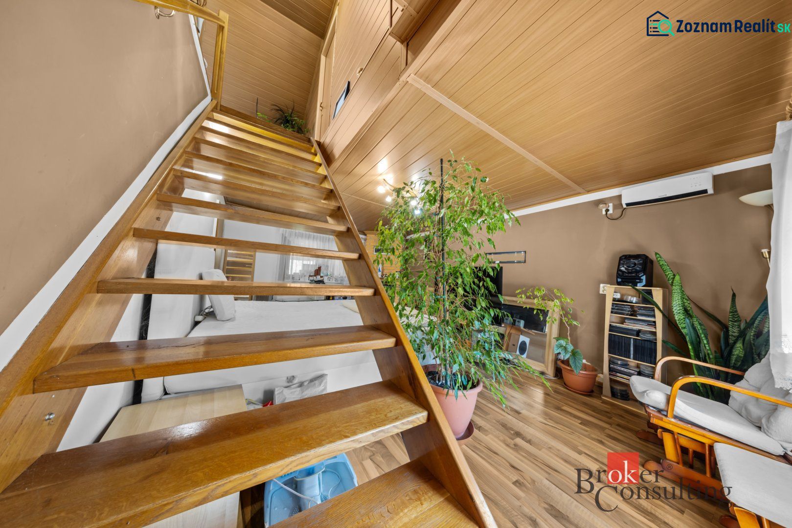 Wooden stairs and furniture in the interior of a family house with a wooden decor floor.
