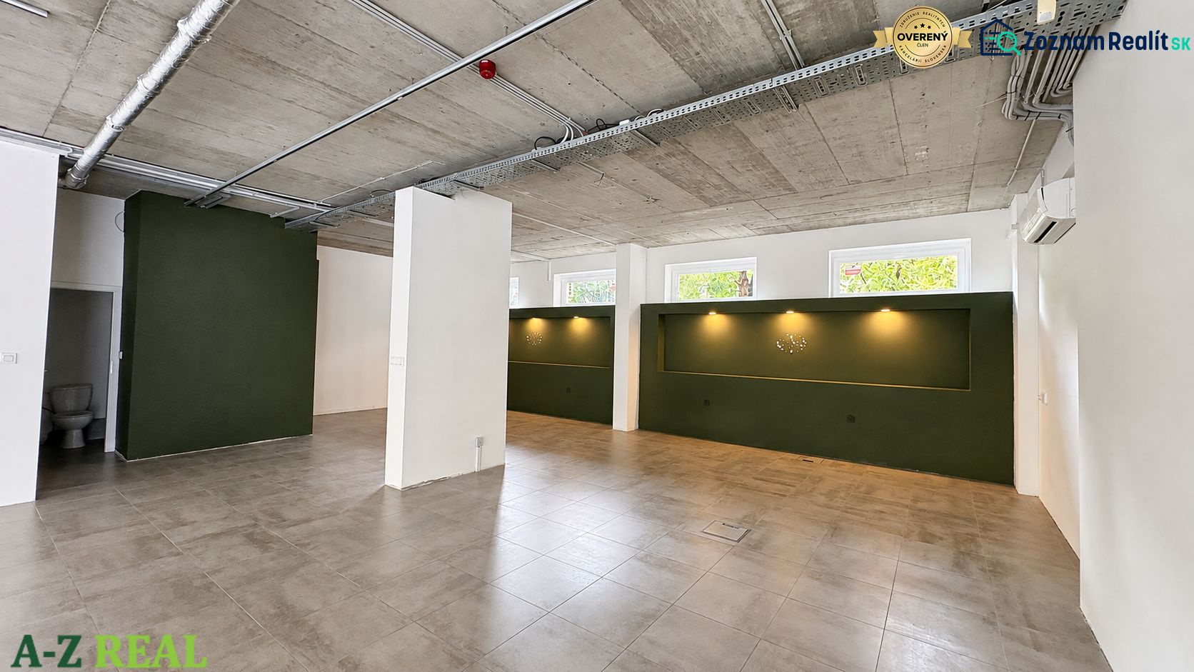 Commercial spaces with light brown flooring and dark green walls.