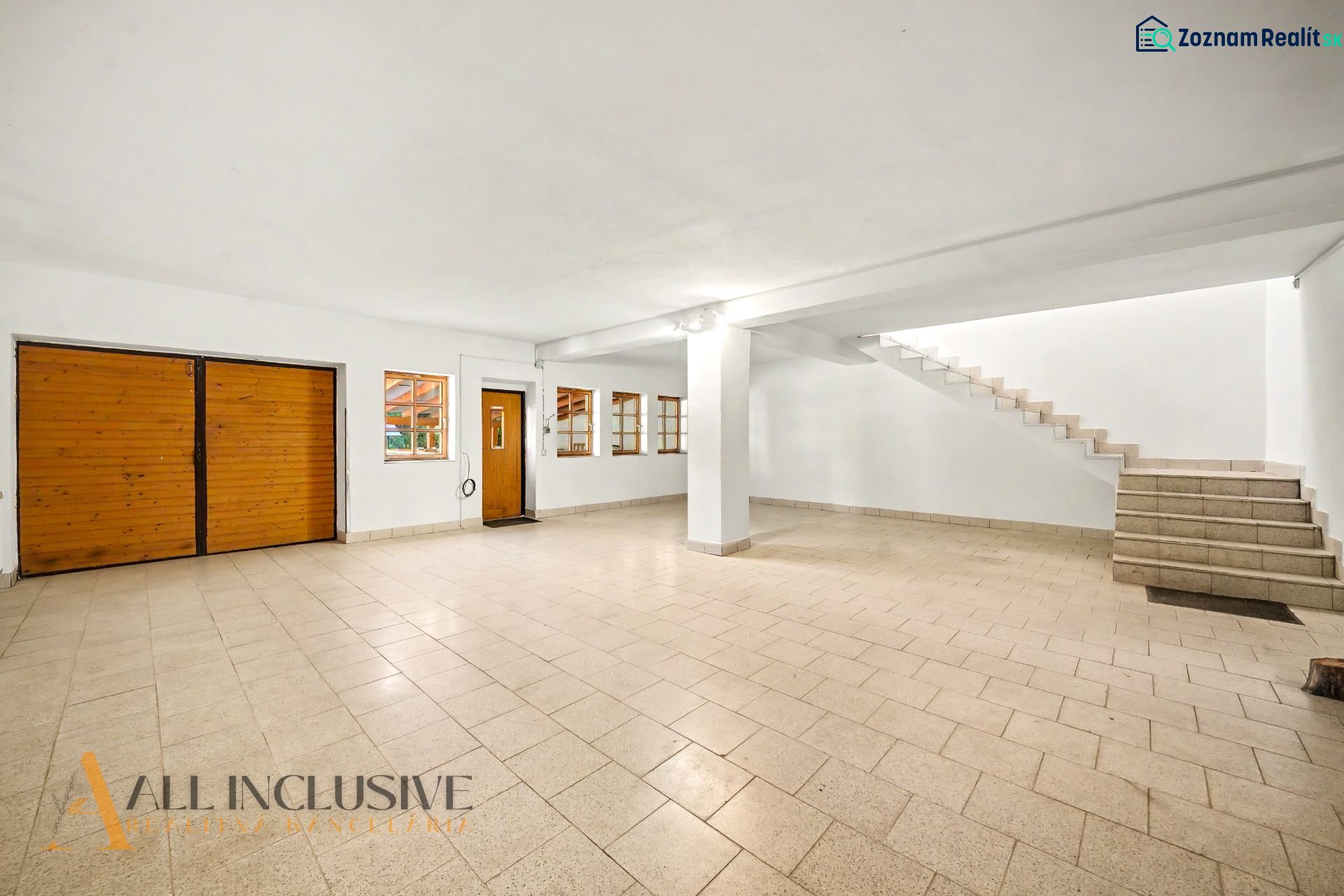 Spacious room with tiles and wooden doors, suitable for residential land.