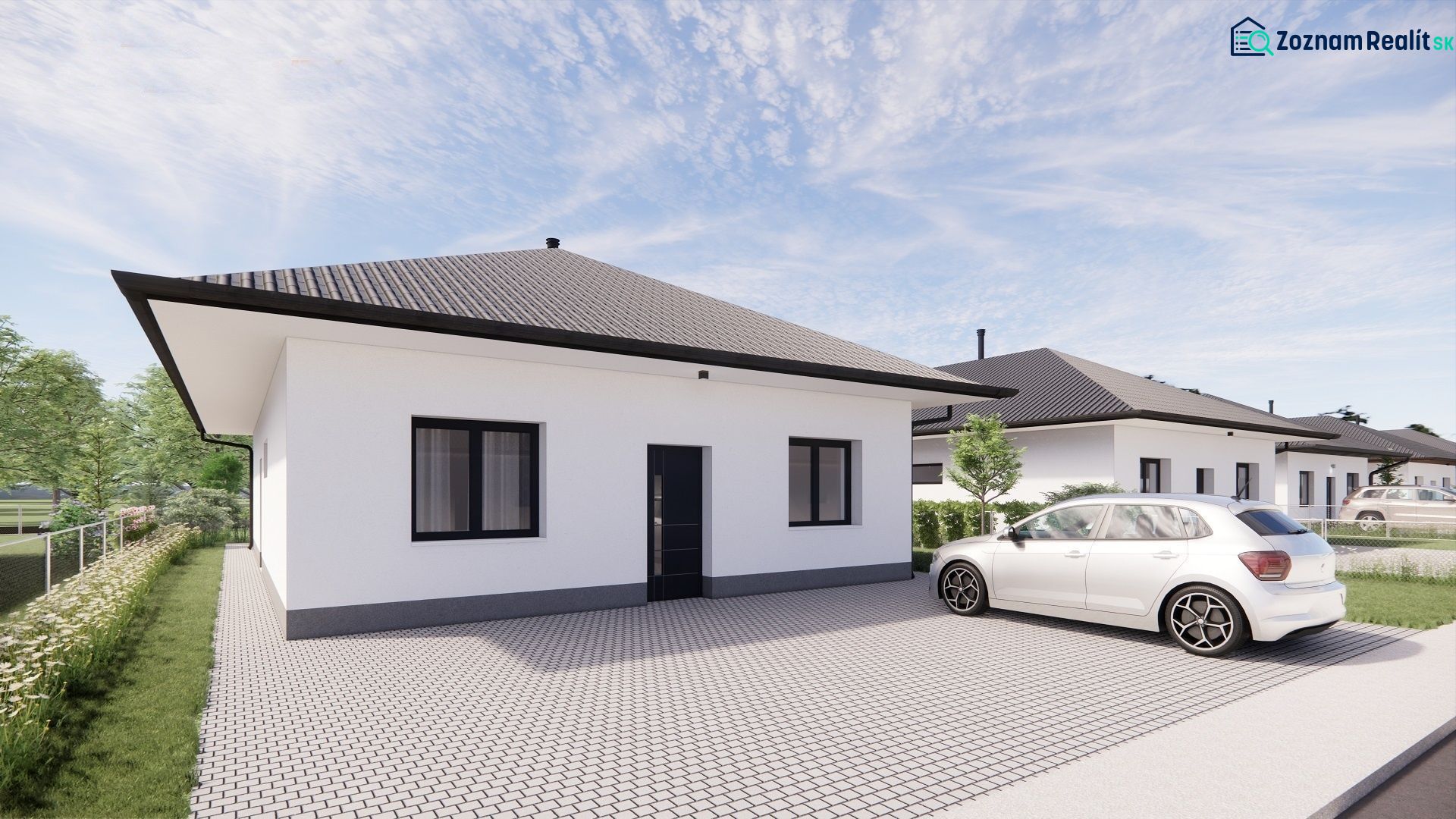 A family house in Prašník with a white facade, gray roof, and adjacent parking lot.