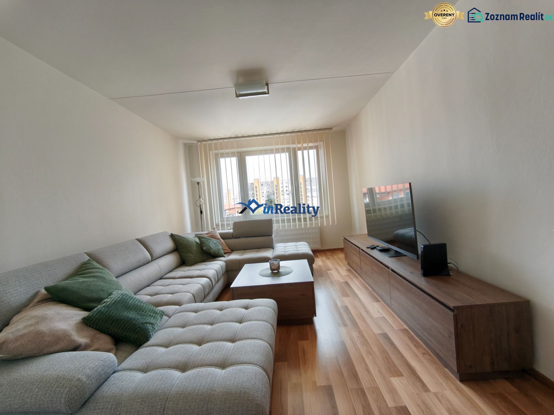 Living room in a 3-room apartment with a sofa and a wooden decor floor.