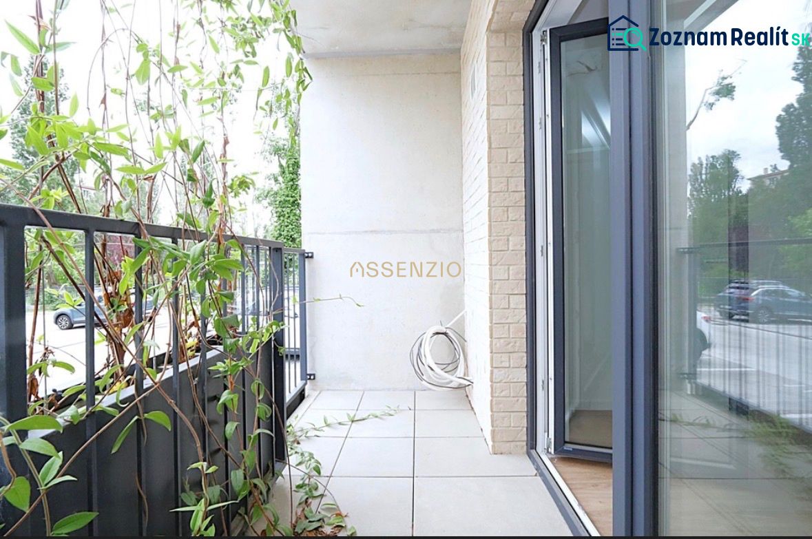 A balcony with plants in a studio apartment, opening to the exterior of Bratislava - Rača.
