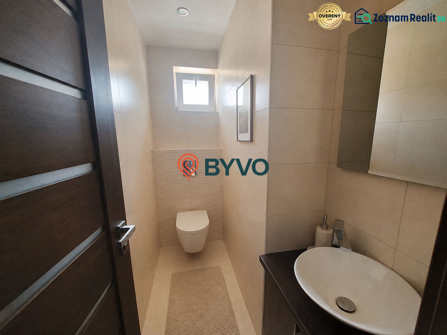 Bathroom in a 4-room apartment with a sink, toilet, and tiles in a subtle design.